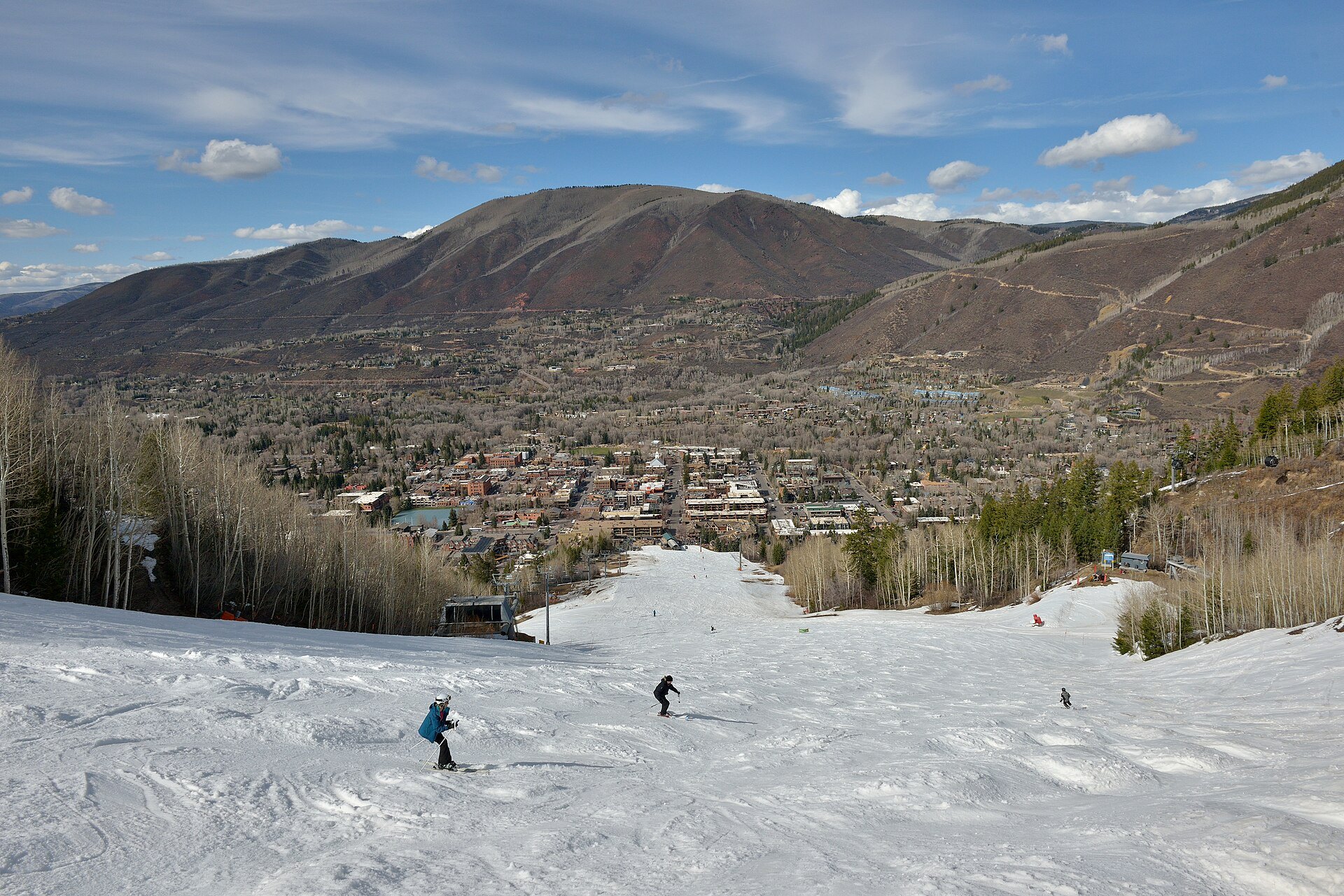 Skiers on Aspen Mountain above the town of Aspen, Colorado