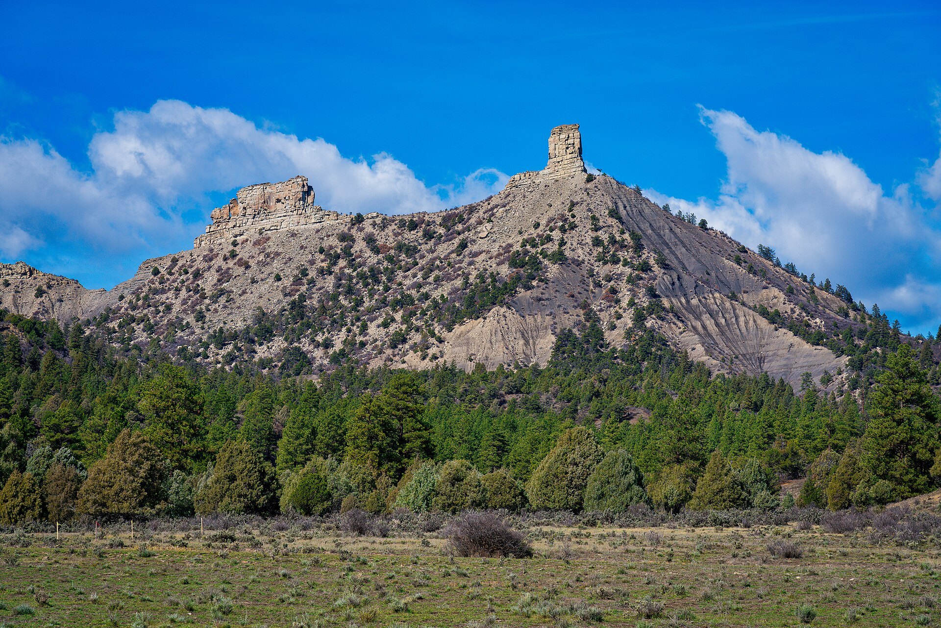 Chimney Rock and Companion Rock spires rising above the mesa at Chimney Rock National Monument, Colorado
