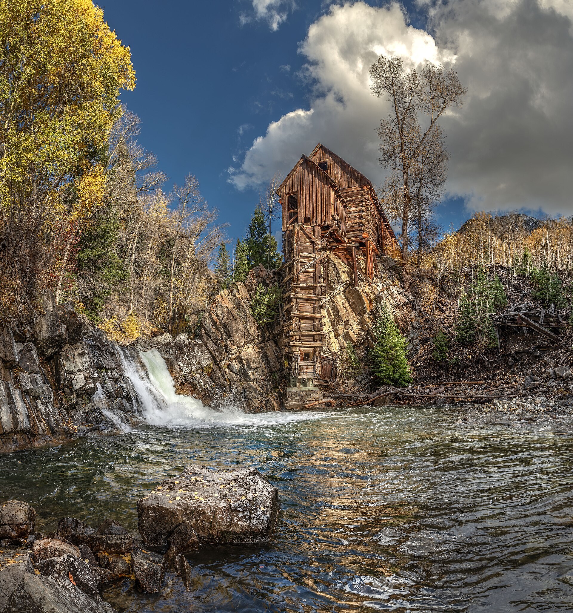Crystal Mill and the waterfall below it under dramatic clouds