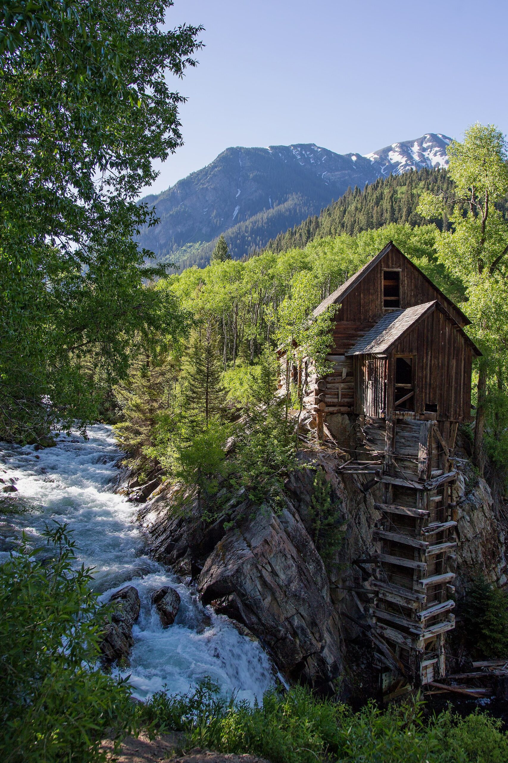 Crystal Mill with snowy peaks beyond in early summer