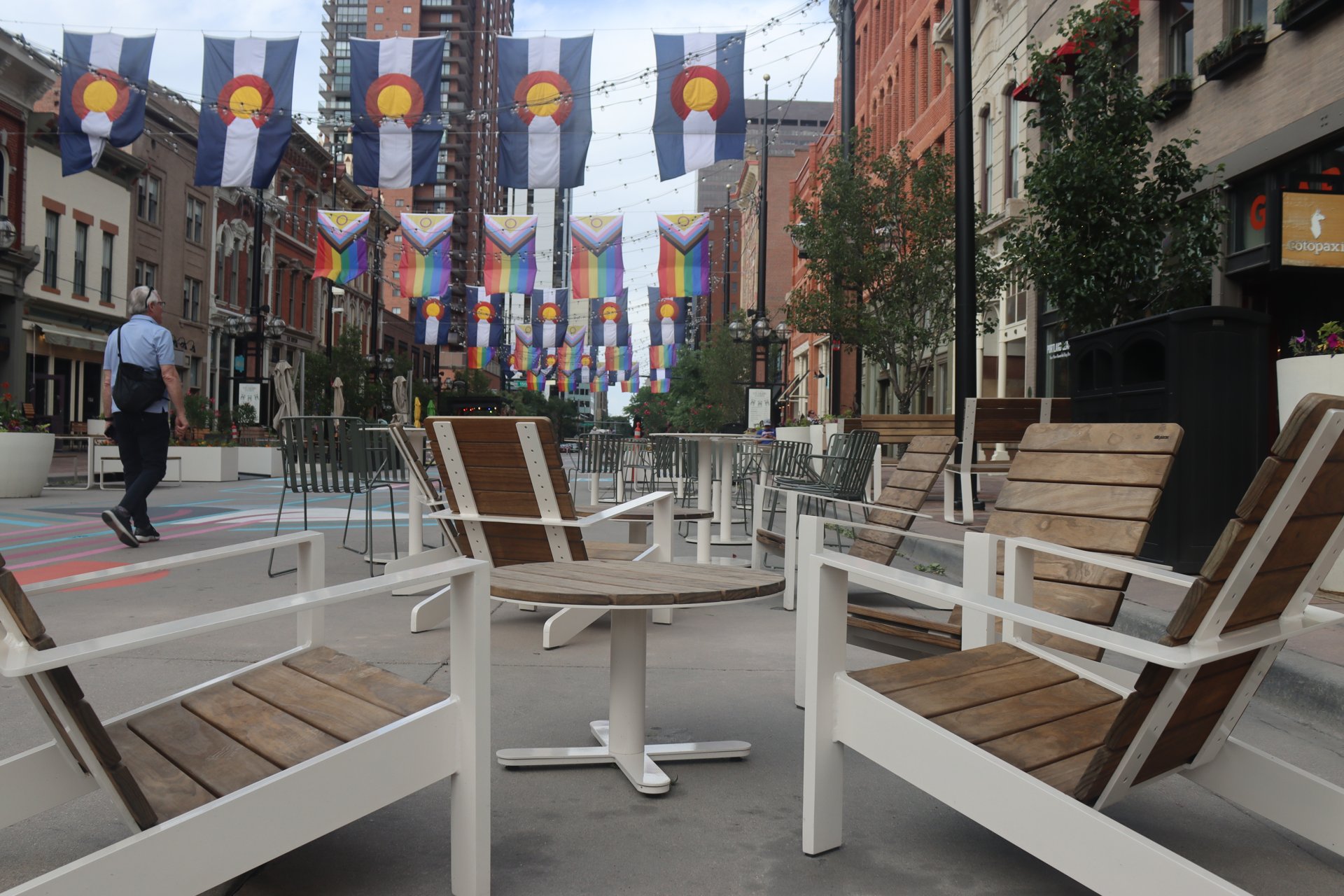 Outdoor seating under banners on Larimer Square