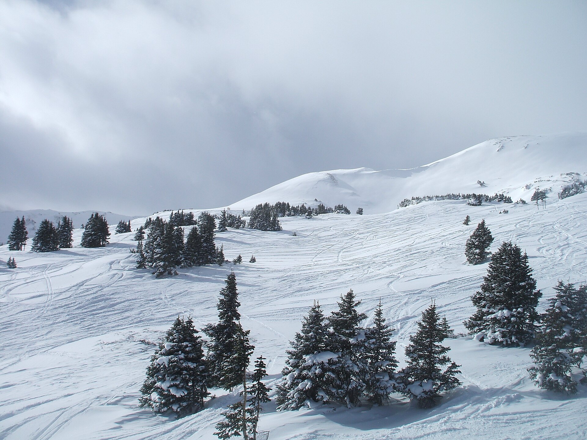 Above-timberline terrain under a cloudy sky at Loveland Ski Area
