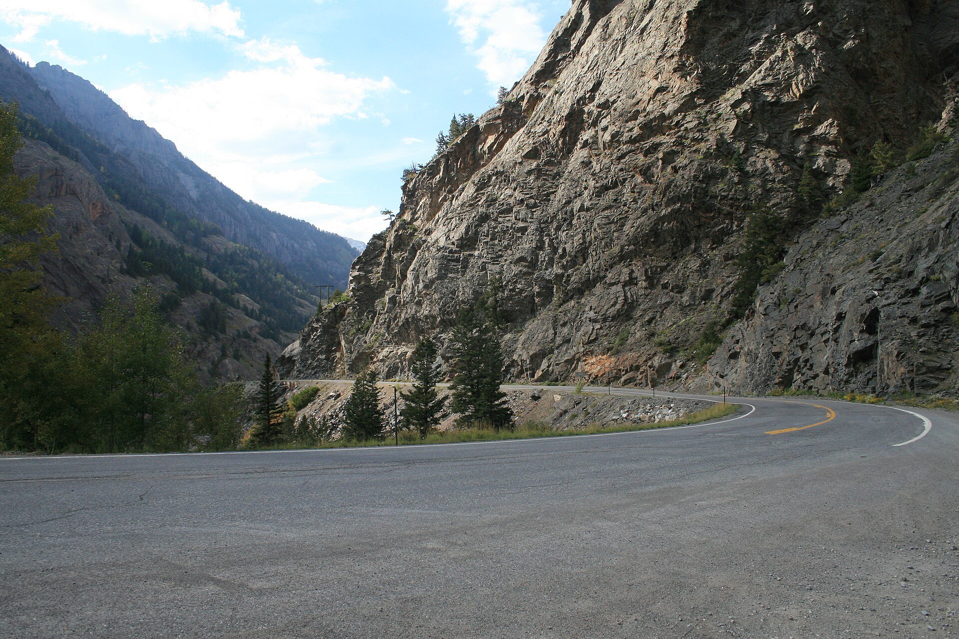 Curve below a rock wall on the Million Dollar Highway between Red Mountain Pass and Ouray