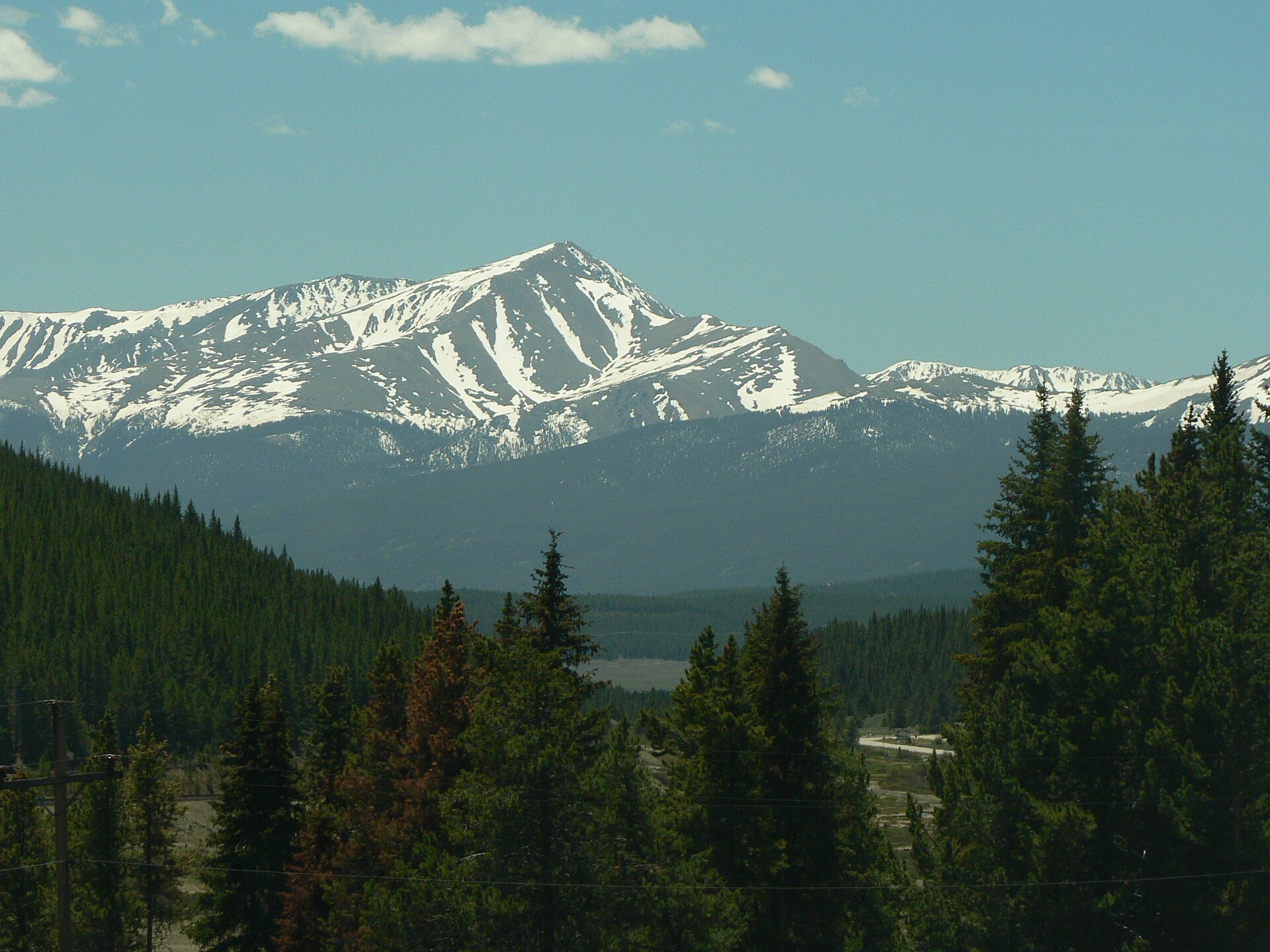 Mount Elbert in the Sawatch Range seen beyond the pines in June