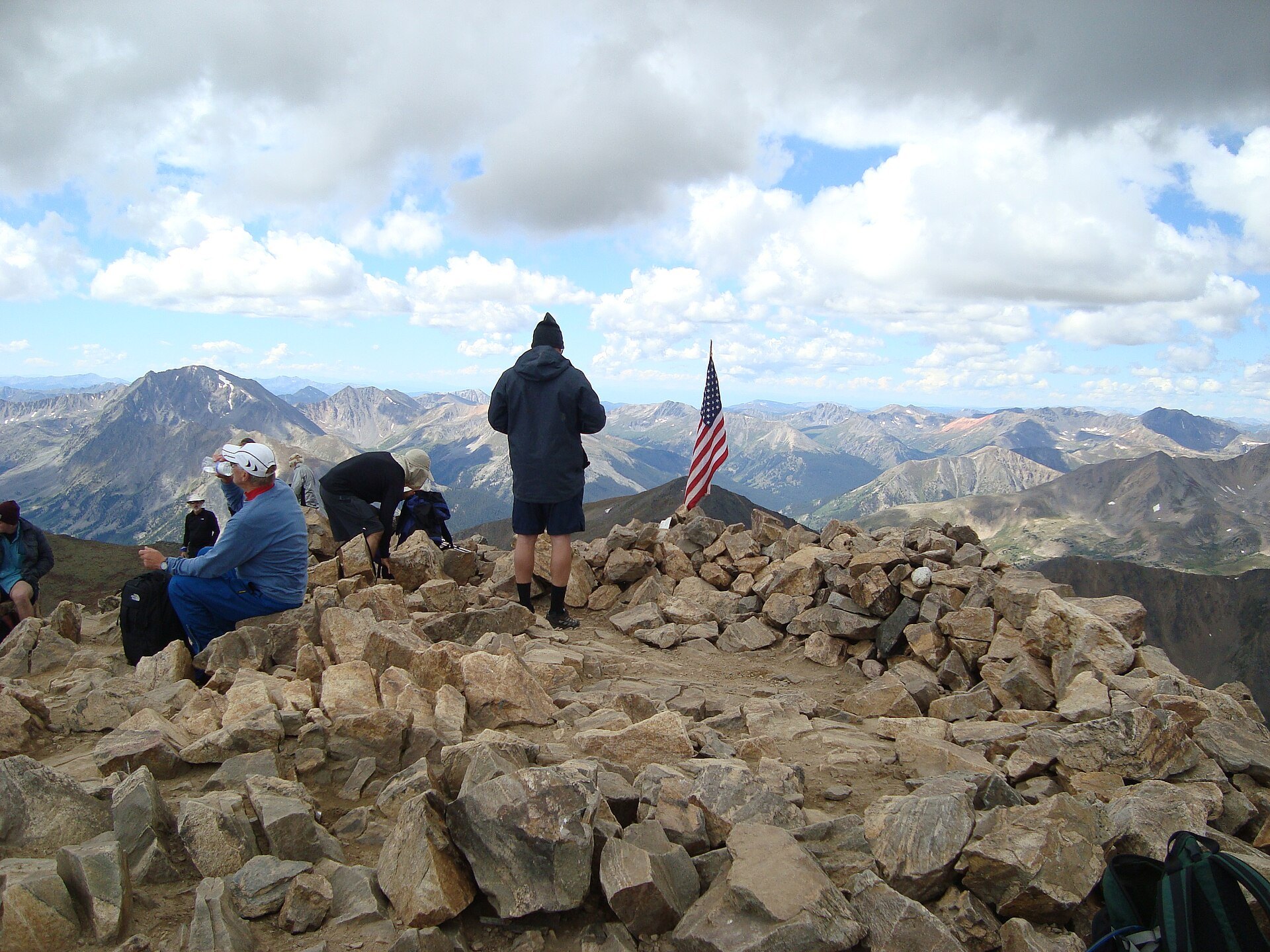Hikers resting on the rocky 14,440-foot summit of Mount Elbert
