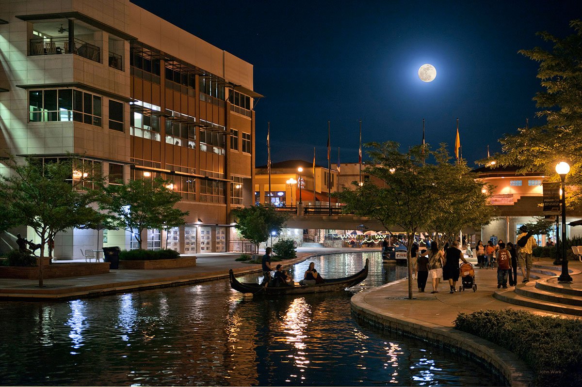 Pueblo Riverwalk at night under a full moon