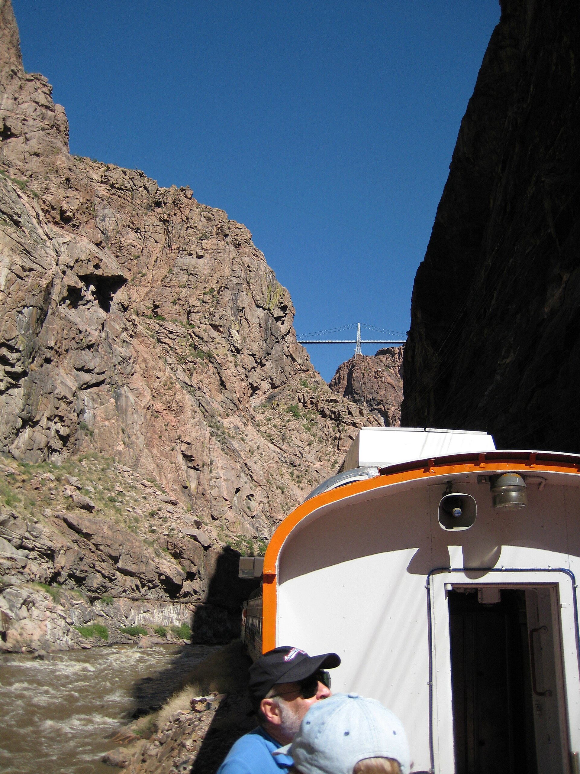 Open-air car of the Royal Gorge train between canyon walls