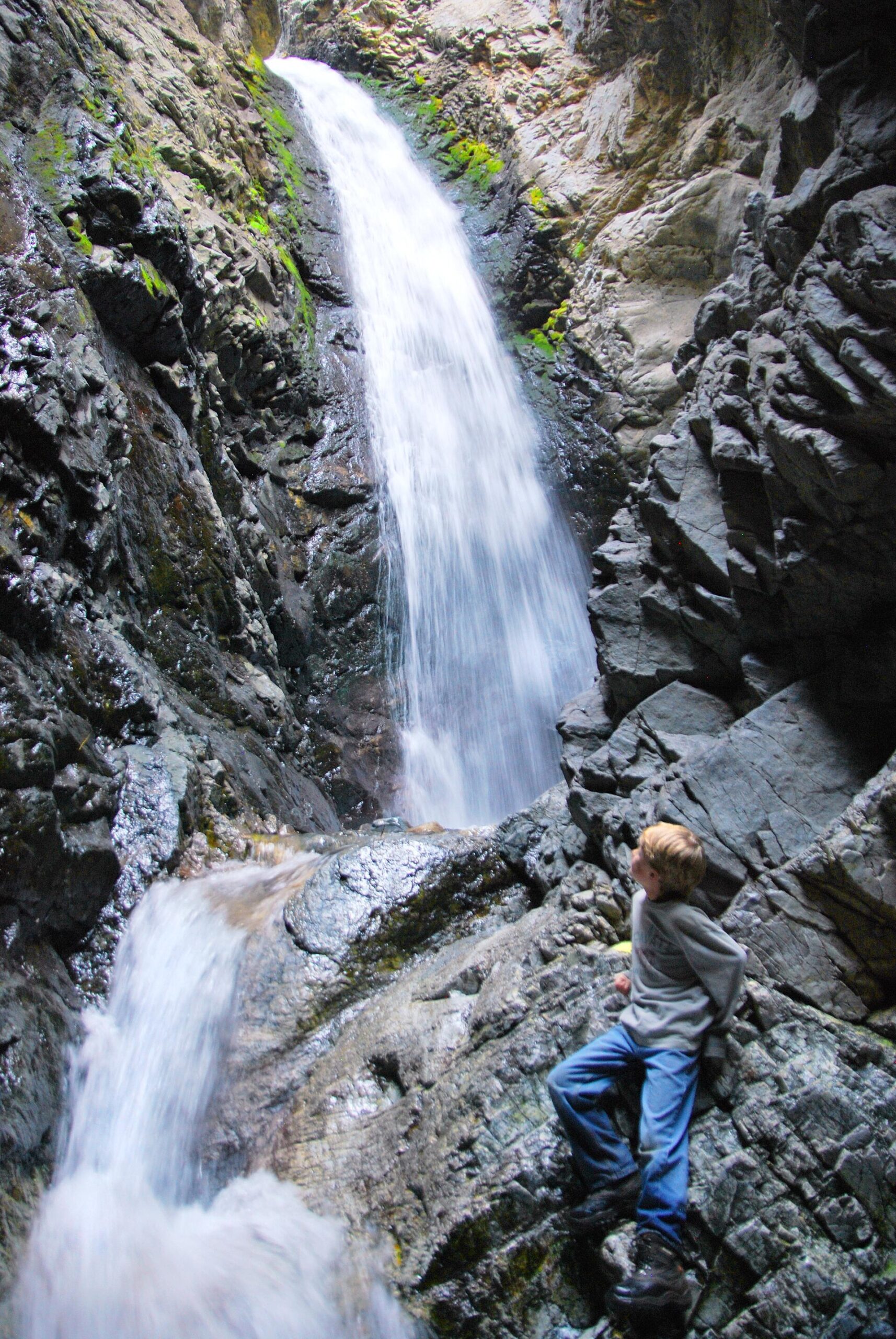 Visitor climbing beside Zapata Falls