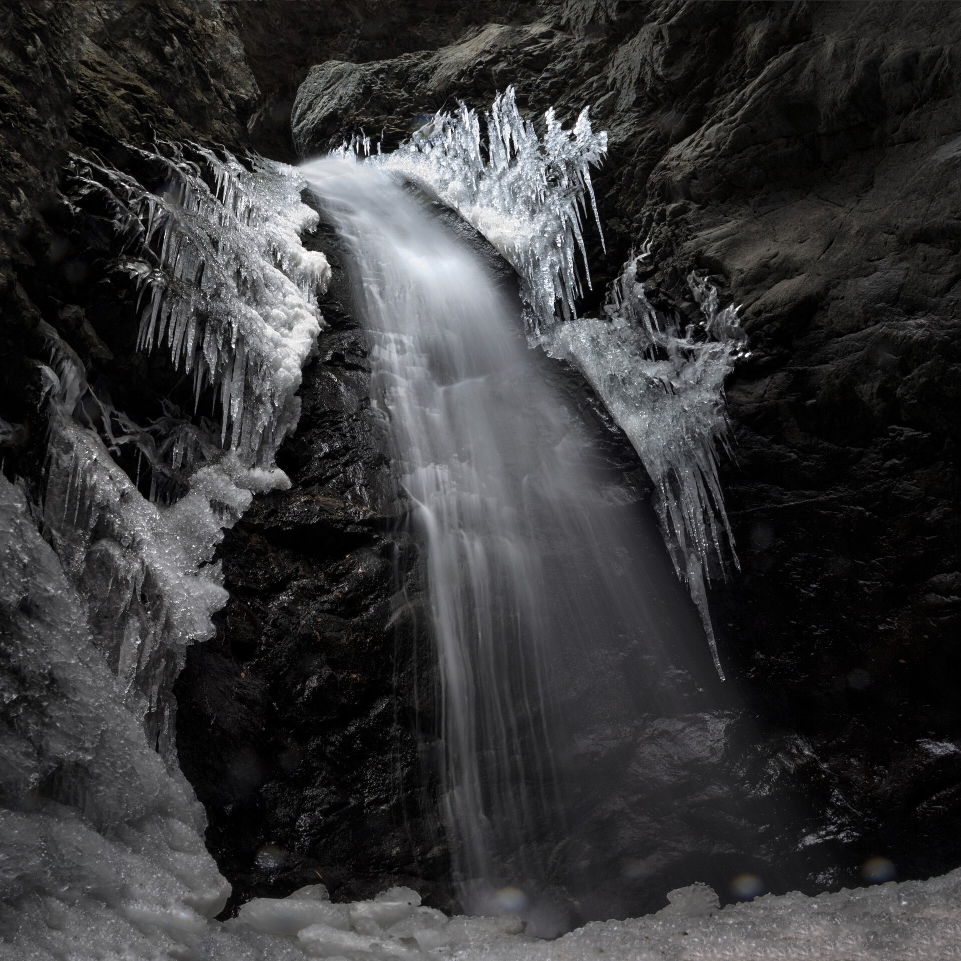 Black and white view of Zapata Falls with icicles